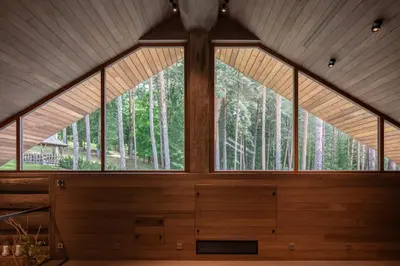 a large window in a room with trees in the background at Esperanza Lake Resort, a Member of Design Hotels in Trakai