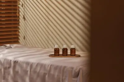 three bottles of honey on a tray on a bed at Esperanza Lake Resort, a Member of Design Hotels in Trakai