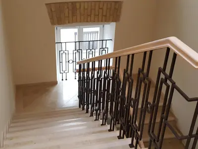 a staircase in a house with a stair railing at City Dawn Gate Apartment in Vilnius