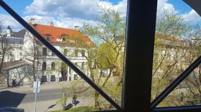 a view of a building from a window at City Dawn Gate Apartment in Vilnius
