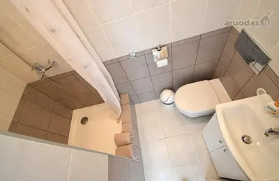a small bathroom with a toilet and a sink at Vilnius Town Apartments in Vilnius
