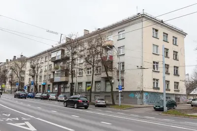 a street with cars parked in front of a building at Vilnius Town Apartments in Vilnius