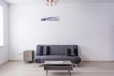 a living room with a couch and a table at Sandra apartamentai in Kaunas