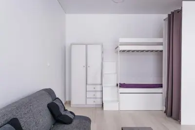 a living room with a couch and two bunk beds at Sandra apartamentai in Kaunas