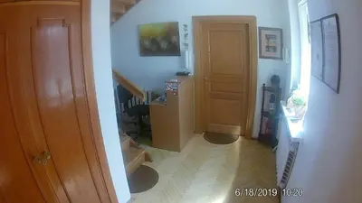 a hallway with a staircase leading to a room with a door at Family in Kaunas