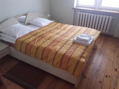 a bedroom with a bed with a striped comforter at Family in Kaunas