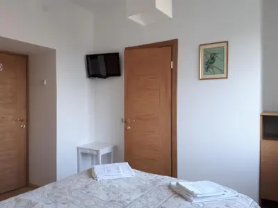 a bedroom with a bed with two towels on it at Family in Kaunas