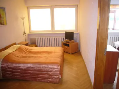 a bedroom with a bed and a television in it at Family in Kaunas