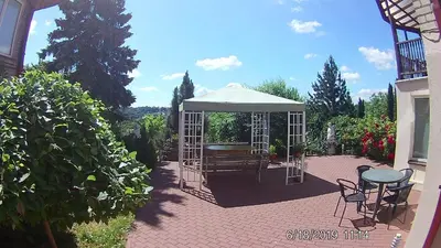 a gazebo with a bench and a table at Family in Kaunas