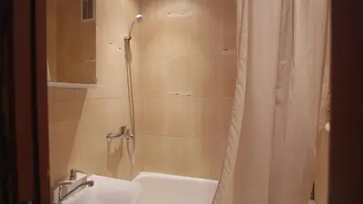 a bathroom with a shower with a tub and a sink at Nature lovers place in Varėna