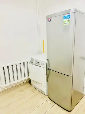 a refrigerator and a dishwasher in a room at Ezero apartamentai in Šiauliai