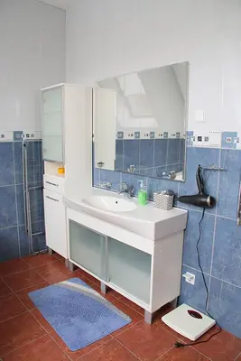 a bathroom with a sink and a mirror at Apartamentai Luna in Panevėžys