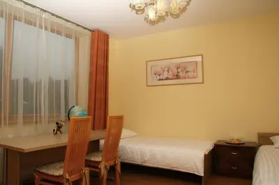 a bedroom with a desk and a table and chairs at Apartamentai Luna in Panevėžys