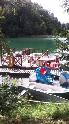 two boats are docked at a dock on a lake at Ginto svetingi namai in Vilnius