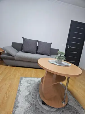 a living room with a couch and a table at Apartamentai Druskininku centre in Druskininkai