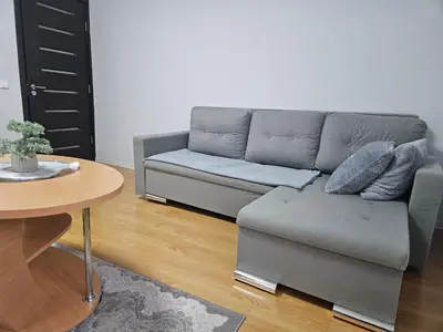 a living room with a couch and a table at Apartamentai Druskininku centre in Druskininkai