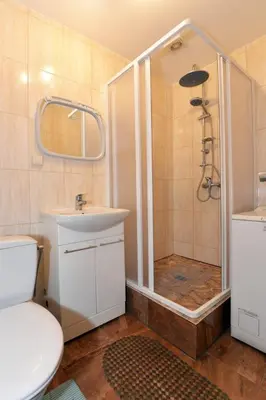 a bathroom with a shower and a toilet and a sink at Apartamentai Druskininku centre in Druskininkai