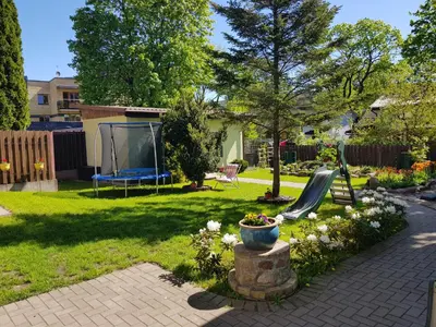a yard with a slide and a playground at Zveryno guest house in Vilnius