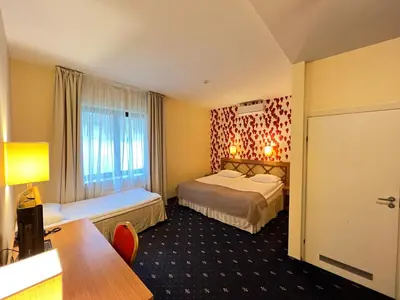 a hotel room with a bed and a window at Park Villa Hotel in Vilnius