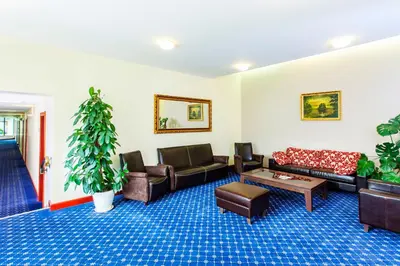 a living room with couches and a coffee table at Park Villa Hotel in Vilnius