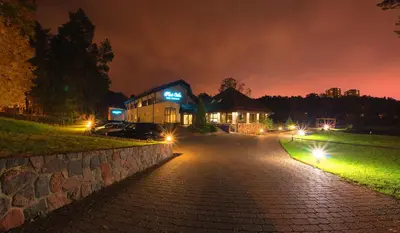 a house lit up at night with lights at Park Villa Hotel in Vilnius