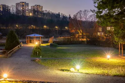 a park with a gazebo and lights at night at Park Villa Hotel in Vilnius