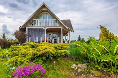 a house with a garden in front of it at Vila Terra Resort in Girsteitiškis