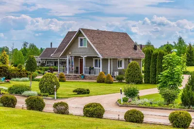 a house with a garden and a driveway at Vila Terra Resort in Girsteitiškis