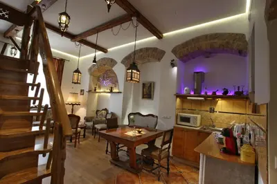 a kitchen and living room with a table and a dining room at Vokiečių g. in Vilnius