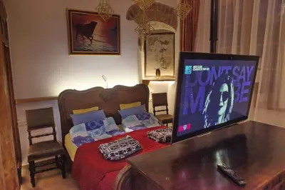 a bedroom with a bed with a monitor on it at Vokiečių g. in Vilnius