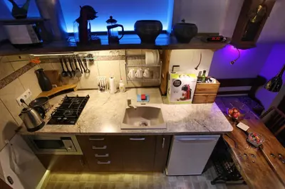 a small kitchen with a stove and a sink at Vokiečių g. in Vilnius