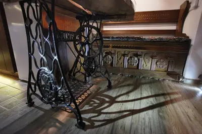 an ornate metal crib in a room with a piano at Vokiečių g. in Vilnius