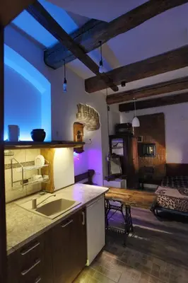 a kitchen with a sink and a table in a room at Vokiečių g. in Vilnius
