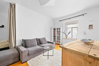 a living room with a couch and a table at Cozy appartment in the Heart of Old Town with free parking in Vilnius