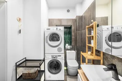 a bathroom with a washer and dryer at Cozy appartment in the Heart of Old Town with free parking in Vilnius