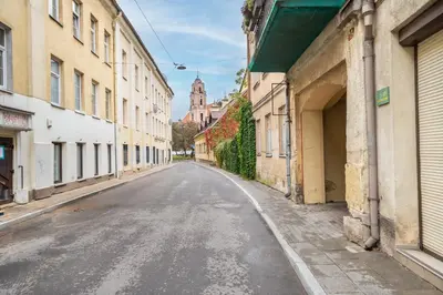 an empty street in an old town with buildings at Cozy appartment in the Heart of Old Town with free parking in Vilnius
