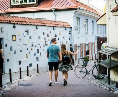 a man and a woman walking down a street at Cozy appartment in the Heart of Old Town with free parking in Vilnius