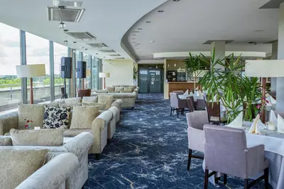 a waiting room with couches and tables and windows at Grand SPA Lietuva Hotel Lietuva in Druskininkai