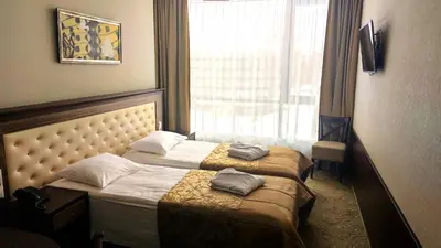 a hotel room with two beds and a window at Grand SPA Lietuva Hotel Lietuva in Druskininkai