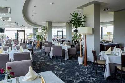 a dining room with white tables and chairs at Grand SPA Lietuva Hotel Lietuva in Druskininkai