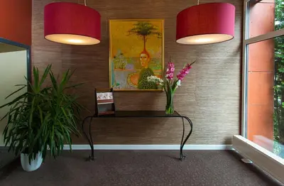 a room with two lamps and a table with flowers at MEDEA Apartments by UPA in Druskininkai