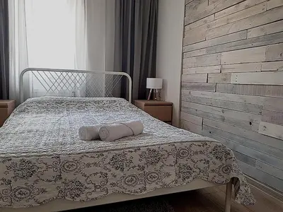 a bedroom with a bed with two pillows on it at Dp Art 14 OLD TOWN Self check in in Kaunas