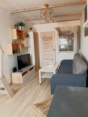 a living room with a couch and a tv at Dp Art 14 OLD TOWN Self check in in Kaunas