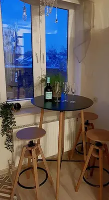 a table with glasses and a bottle of wine on it at Dp Art 14 OLD TOWN Self check in in Kaunas