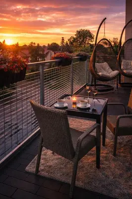 a patio with a table and chairs on a balcony at Ąžuolo apartamentai in Birštonas