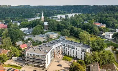 an aerial view of a city with a large building at Ąžuolo apartamentai in Birštonas