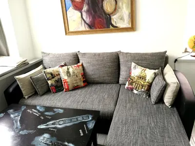 a living room with a couch with pillows at Vilnius apartment with stained glass in Vilnius