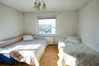 a bedroom with two beds and a window at Svečiuose pas Aldoną in Druskininkai