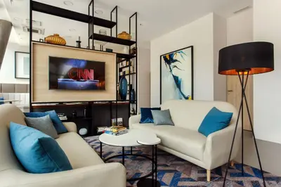 a living room with two couches and a tv at Courtyard by Marriott Vilnius City Center in Vilnius