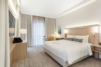 a hotel room with a large bed and a desk at Courtyard by Marriott Vilnius City Center in Vilnius